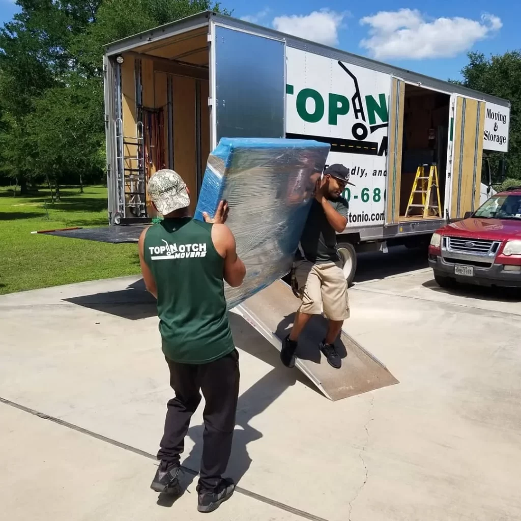 movers moving items and loading into a moving truck