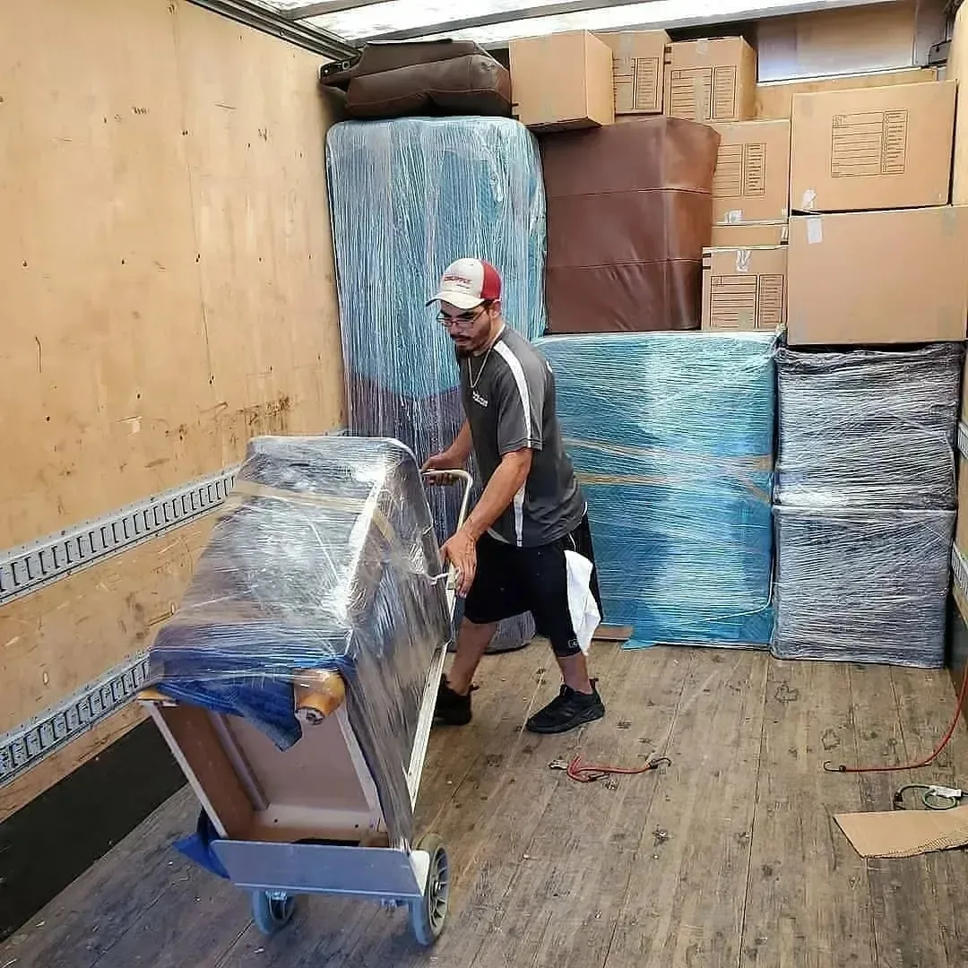 a mover loading a packing items onto a moving truck